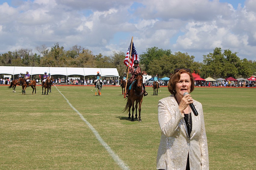 Natalie Smith of the Music Compound belts out the National Anthem before the match at the Sarasota Polo Club March 8.