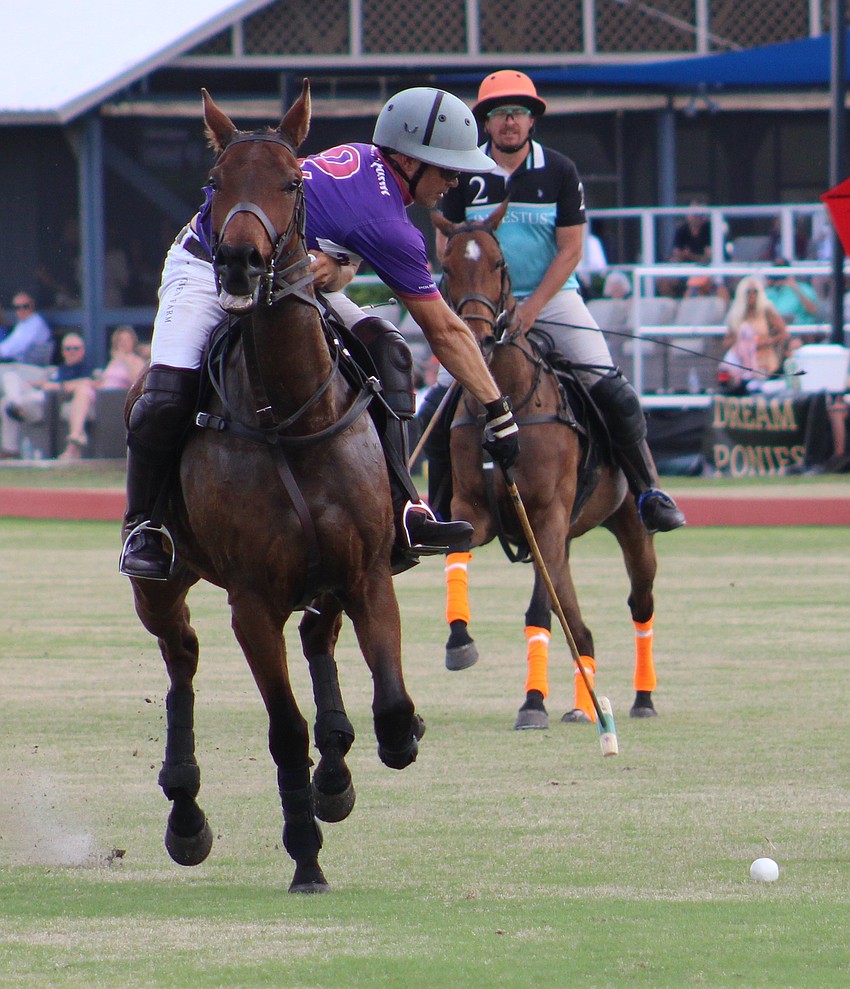 Willie Jumer twists his body while going full speed to make a pass March 8 at the Sarasota Polo Club.