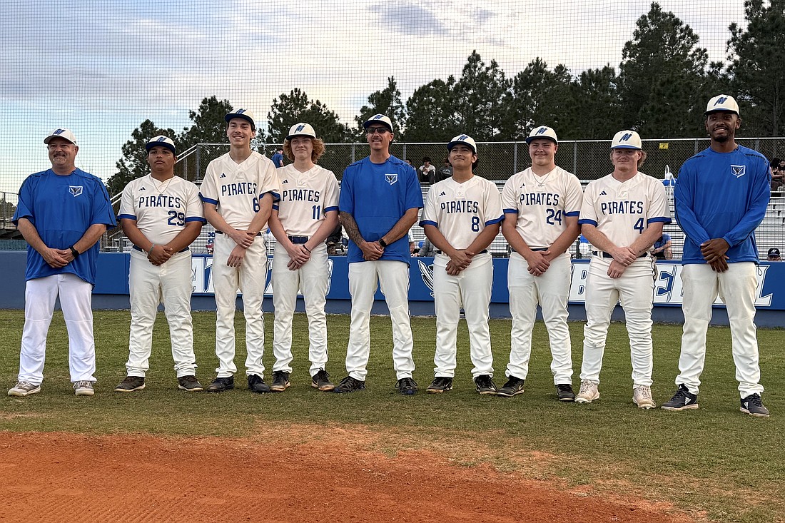 Matanzas honored its six seniors before winning in extra innings on March 6. From left: assistant coach Tommy Ascone, Monte Strickland, Nigel Sejda, Nolan Schmidt, head coach Sean McManus, Roberto Reyes, Damian Paulsen, Tate Conner and assistant coach Robert Bell. Courtesy photo by Zach Rigney