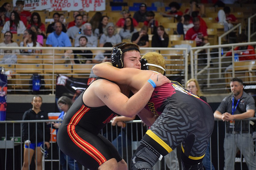 Blake Roulund (left) tussles with West Nassau's Bryce Mangum (right) in the first round of the 1A state championship at 215 pounds. The Cougar won by fall in three minutes and 30 seconds.