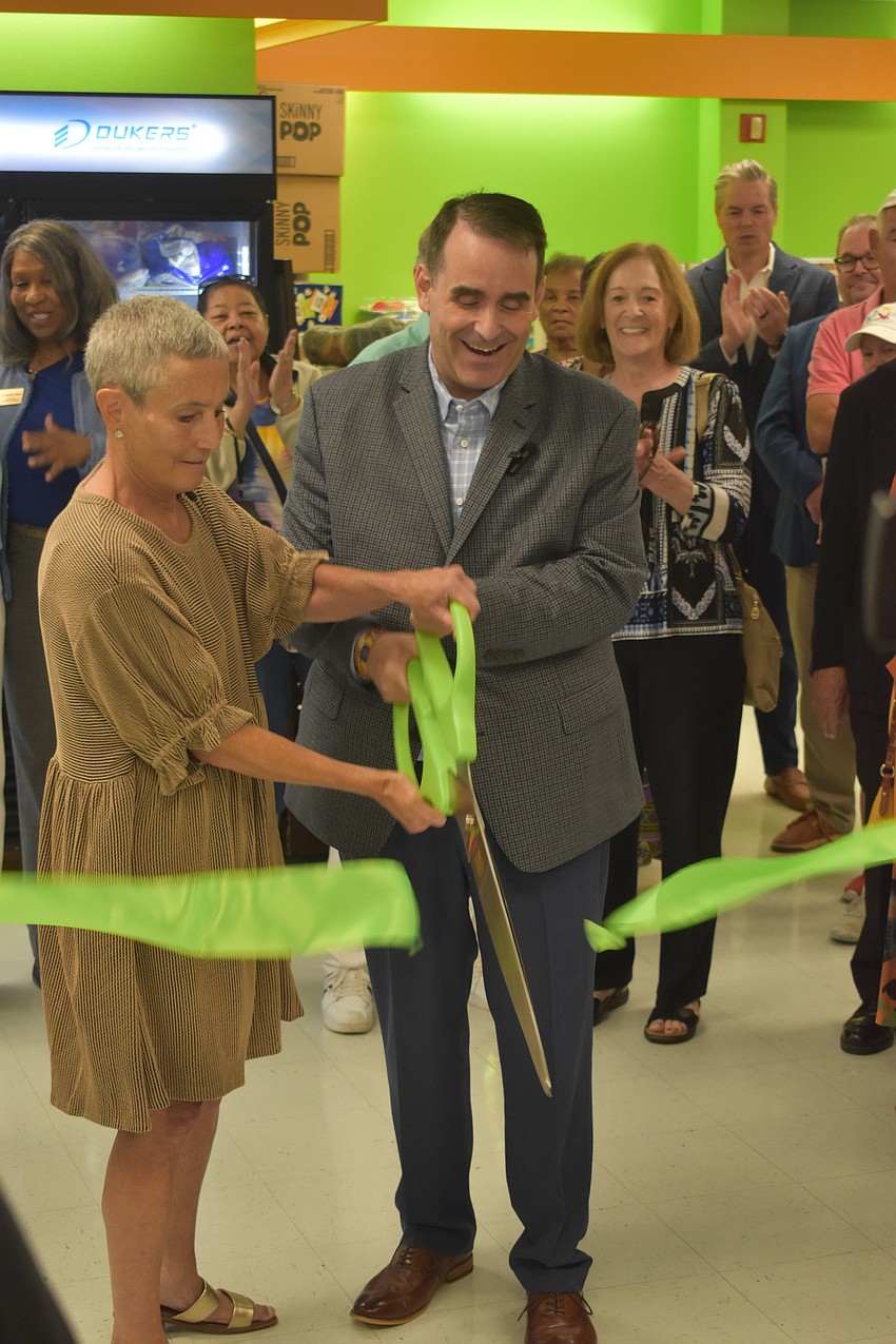 Nelle Miller, president and CEO of All Faiths Food Bank, and John Brothers, president and CEO of the Charles & Margery Barancik Foundation, cut the ribbon.