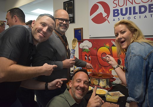 Hysen Muhametaj, Jamison Eige, Ron Major and Sydney Bartlett of Direct Window & Door celebrate Eige's win at the Suncoast Builders Association Chili Cook Off.