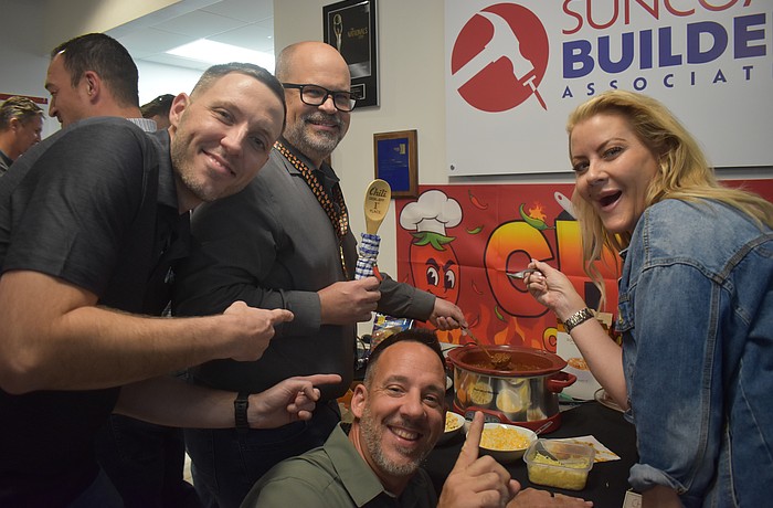 Hysen Muhametaj, Jamison Eige, Ron Major and Sydney Bartlett of Direct Window & Door celebrate Eige's win at the Suncoast Builders Association Chili Cook Off.