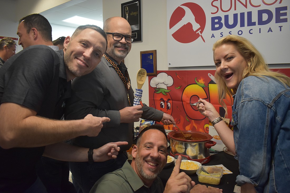 Hysen Muhametaj, Jamison Eige, Ron Major and Sydney Bartlett of Direct Window & Door celebrate Eige's win at the Suncoast Builders Association Chili Cook Off.