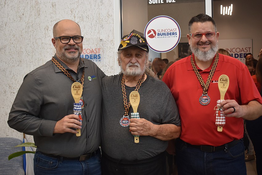 Nokomis's Jamison Eige, Bradenton's Carl Chitjian and Lakeland's Chad Reynolds are awarded first, second and third place in the Chili Cook Off at the Suncoast Builders Association event on March 12.