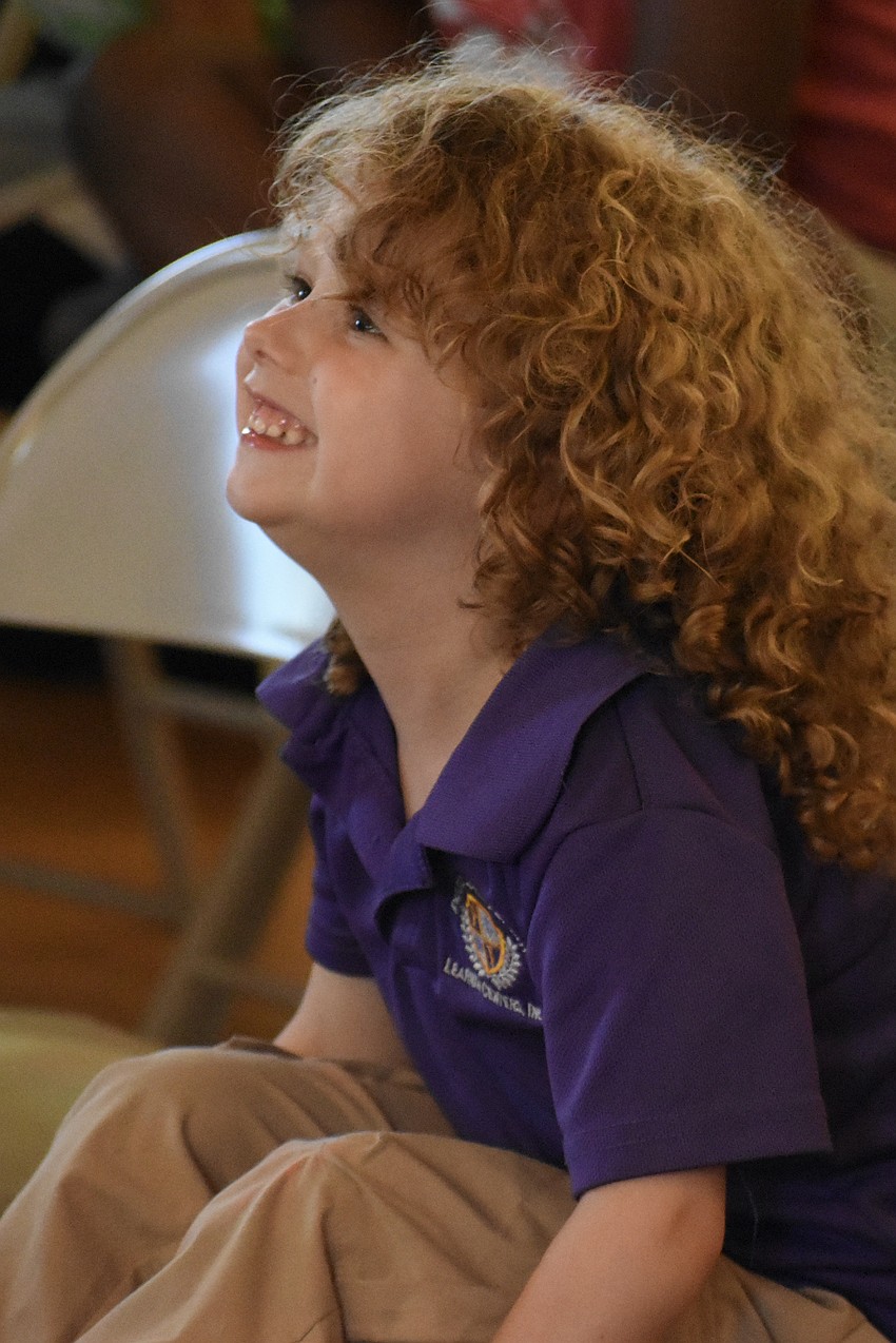 Preschooler E'styn Smith of Precious Jewels Academy watches the presentation.