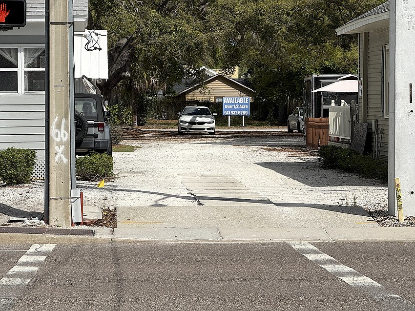 A sign tucked between buildings on Fruitville Road indicates the property is for sale. A Tennessee developer is proposing an apartment building covering the entire block between North Osprey and Gillespie avenues.