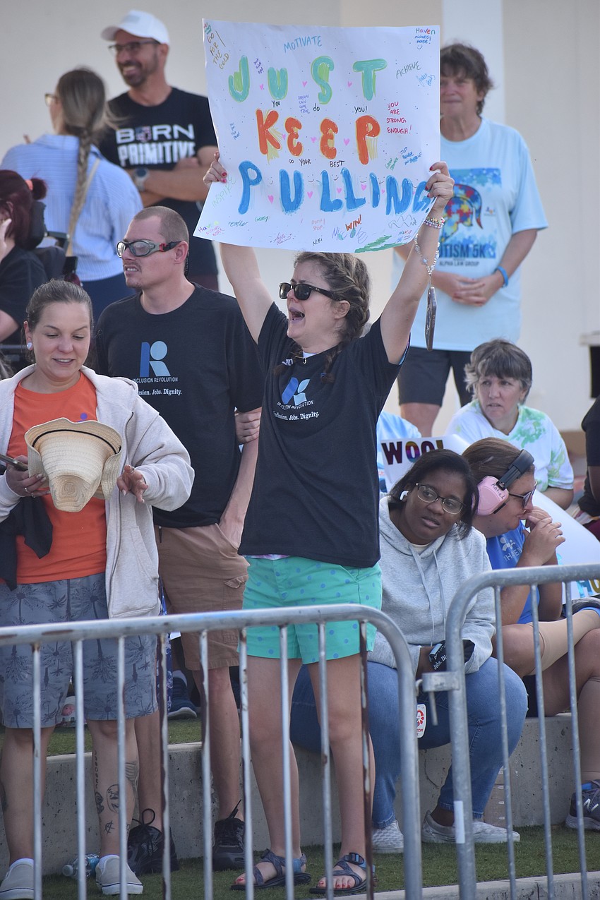 Jacquelyn Bailey, who lives at The Haven, holds up a sign that says 