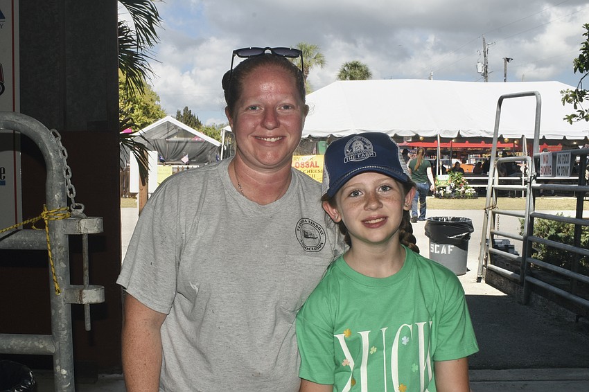 Rebecca Mckeehan and her daughter Merida McKeehan, a third grader who is raising her pig, Rusty, at The Farm.