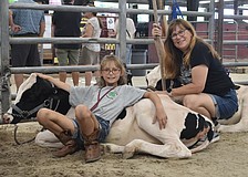 Fourth grader Ava O'Mahoney of 4-H and her mother Megan O'Mahoney spend time with Clover.