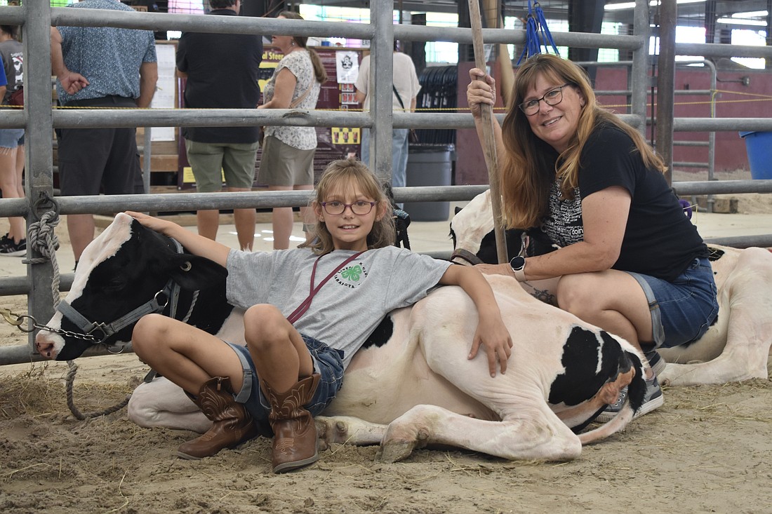 Fourth grader Ava O'Mahoney of 4-H and her mother Megan O'Mahoney spend time with Clover.