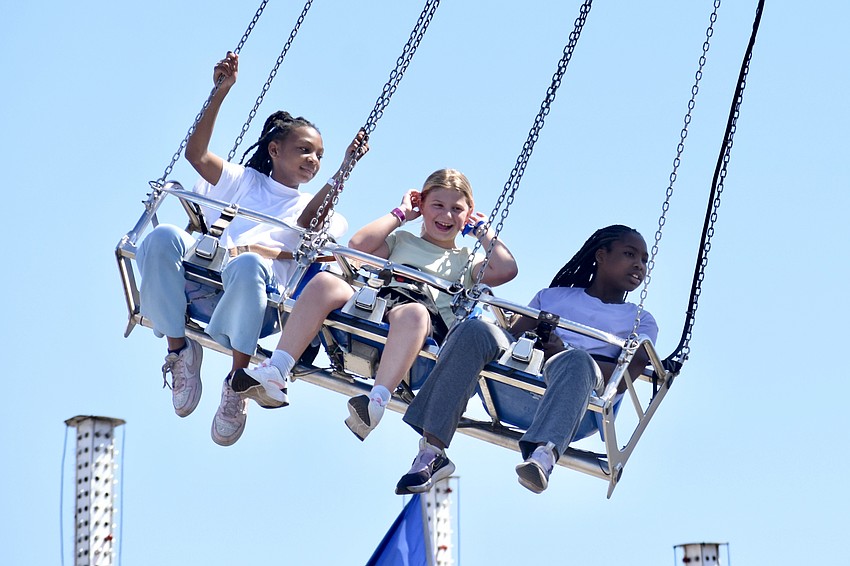 Tara Johnson, 11, Gabrielle Fruzan, 9, and Tyasia Brown, 11, have some high-flying fun.