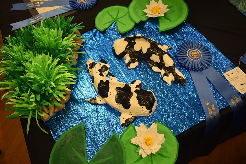 A paper craft by Harper Hicks is displayed in the art area.