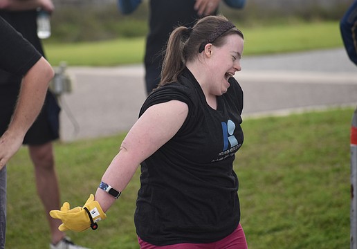 Sarasota's Kelley Rouse celebrates after she participates in the Bus Pull for Inclusion, a fundraiser for the nonprofit Inclusion Revolution, that will assist in providing job-related resources to people with disabilities.