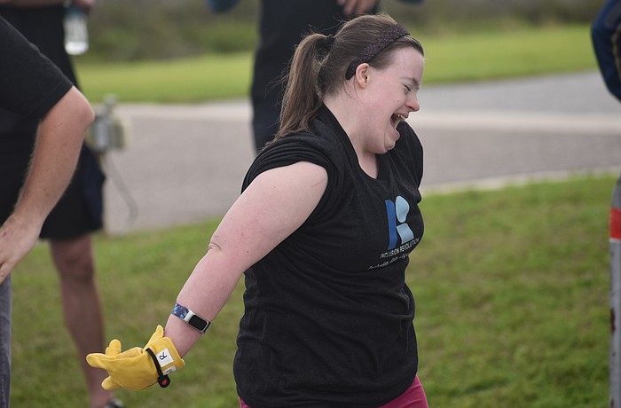 Sarasota's Kelley Rouse celebrates after she participates in the Bus Pull for Inclusion, a fundraiser for the nonprofit Inclusion Revolution, that will assist in providing job-related resources to people with disabilities.