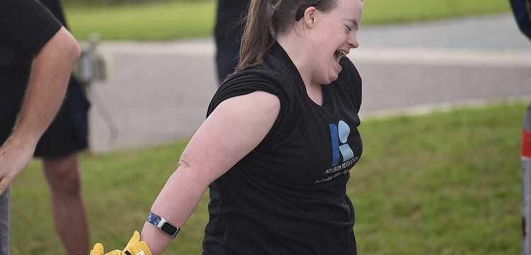 Sarasota's Kelley Rouse celebrates after she participates in the Bus Pull for Inclusion, a fundraiser for the nonprofit Inclusion Revolution, that will assist in providing job-related resources to people with disabilities.