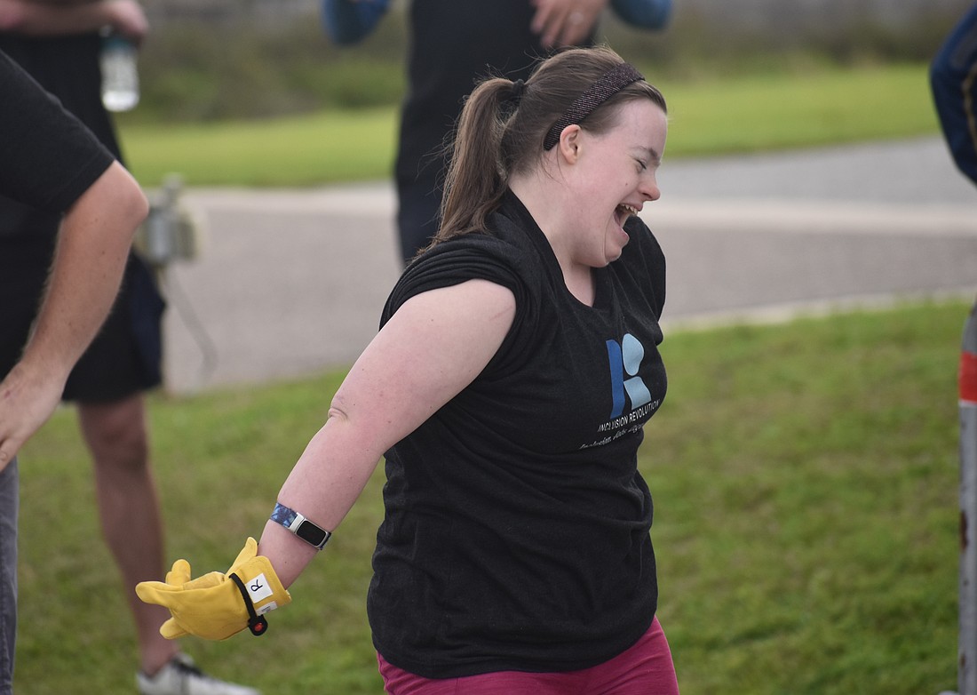 Sarasota's Kelley Rouse celebrates after she participates in the Bus Pull for Inclusion, a fundraiser for the nonprofit Inclusion Revolution, that will assist in providing job-related resources to people with disabilities.