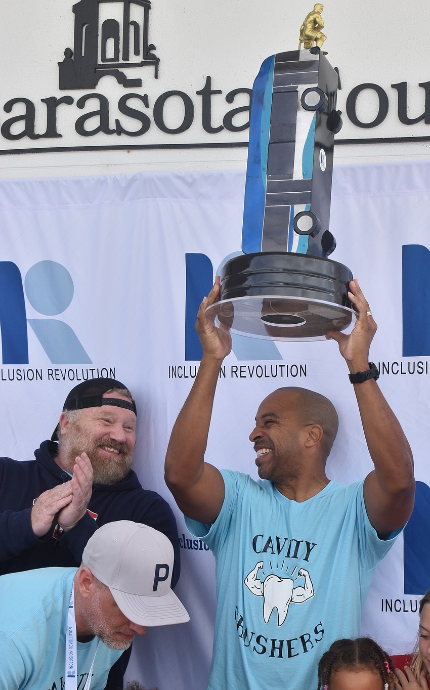Matt Wilmoth and Andre Lewis, who are members of team Cavity Crushers representing A.L.L. About Kids Pediatric Dentistry, celebrate their win with a time of 11:22 seconds.