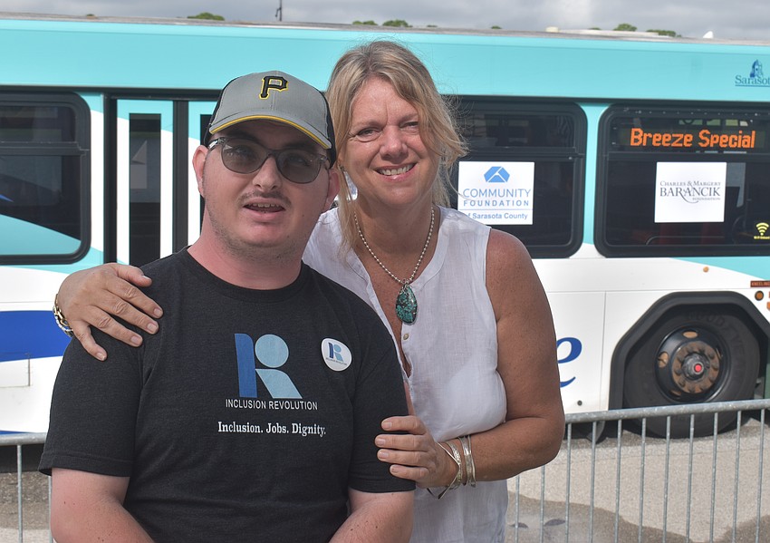 Dylan Mayes, who lives at The Haven, is joined by his mom Laurie Russett after he participates in the Bus Pull for Inclusion.