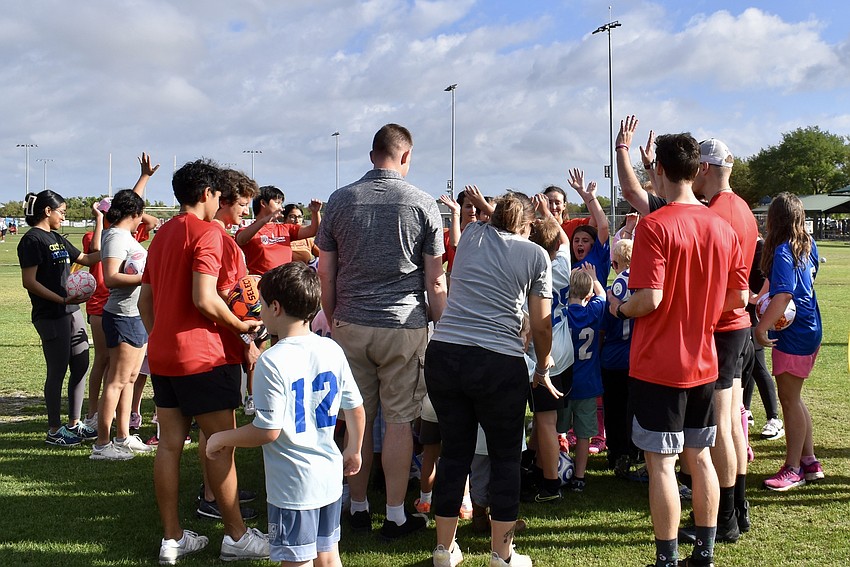 Players, buddies and parents huddle after TOPSoccer practice March 14 at Lakewood Ranch Park.