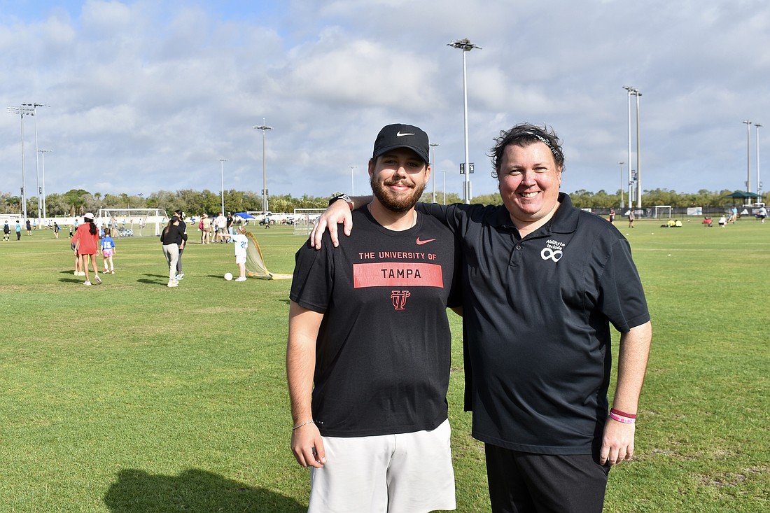 Preston Bowers volunteers for TOPSoccer, and Chris Collins manages the program.
