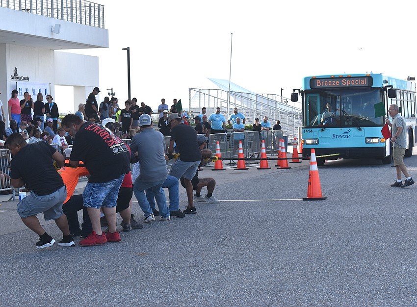 At the Bus Pull for Inclusion, 10 teams compete to see who can pull a 20-ton Sarasota County Breeze Transit bus 30 feet the fastest.