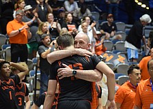 Sarasota boys basketball coach BJ Ivey embraces Johnny Lackaff. The junior guard had a game-high 27 points March 14 in the FHSAA Class 7A state championship, but it wasn't enough to secure a title for the Sailors.