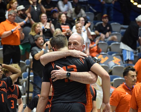 Sarasota boys basketball coach BJ Ivey embraces Johnny Lackaff. The junior guard had a game-high 27 points March 14 in the FHSAA Class 7A state championship, but it wasn't enough to secure a title for the Sailors.