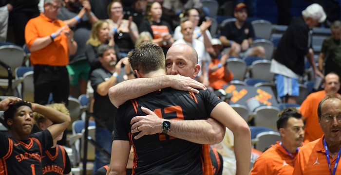 Sarasota boys basketball coach BJ Ivey embraces Johnny Lackaff. The junior guard had a game-high 27 points March 14 in the FHSAA Class 7A state championship, but it wasn't enough for the Sailors.