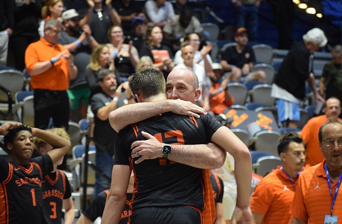 Sarasota boys basketball coach BJ Ivey embraces Johnny Lackaff. The junior guard had a game-high 27 points March 14 in the FHSAA Class 7A state championship, but it wasn't enough for the Sailors.