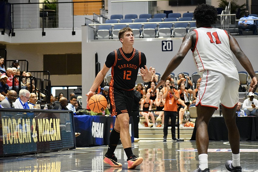 Johnny Lackaff (left) brings the ball upcourt, guarded by Caleb Gaskins (right). The guard more than doubled the five-star forward's 12 points on the night.