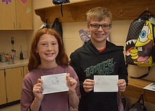 Gilbert W. McNeal Elementary School fourth graders Leona Killion and Michael Chmielarski created business cards as a dancer and a soccer player for the Project T.E.A.C.H. activity on March 12.