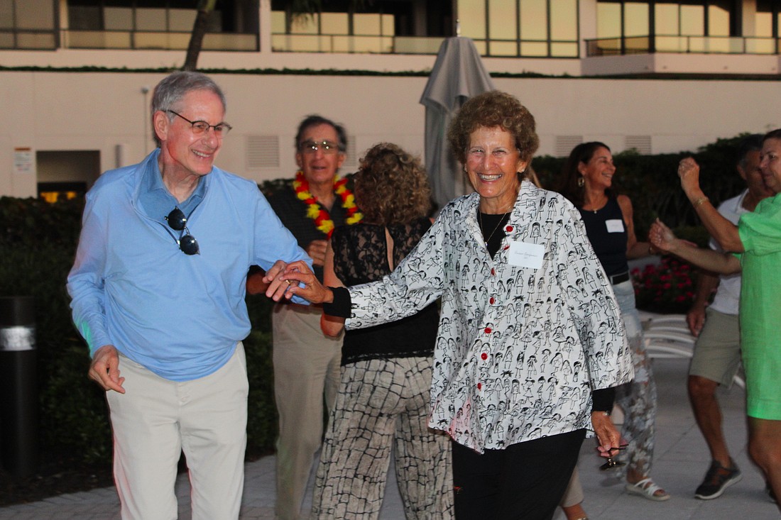 Marc and Susan Benjamin are all smiles on the dance floor as they groove to the Aloha Sharks band March 14 at The Sanctuary.
