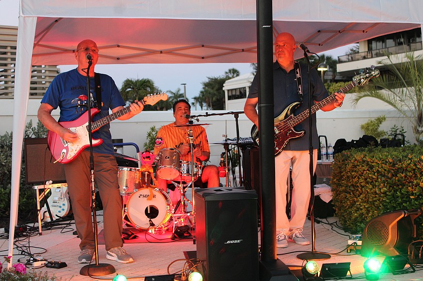 Guitarist Dave Kish, drummer Carmen D'Amico and bassist Scott Savage play at Aloha Sharks.