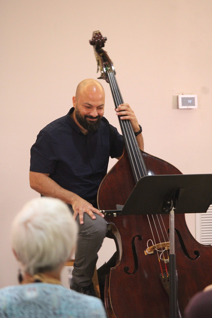 Upright bassist Randy Bordon checks the setlist for the next tune with Los Rumberos.