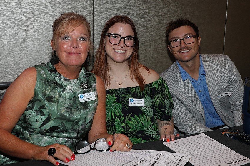 Jenny Hammer, Rachel McDowell and Kevin Rice keep track of the auction winners.