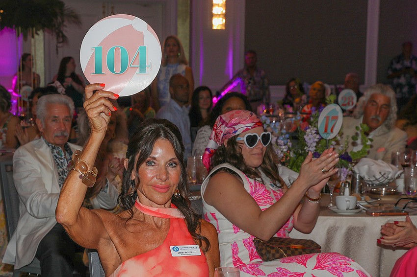 Paddle #104 belongs to board President Janet Boyden, who enjoys eight years and counting on the board.