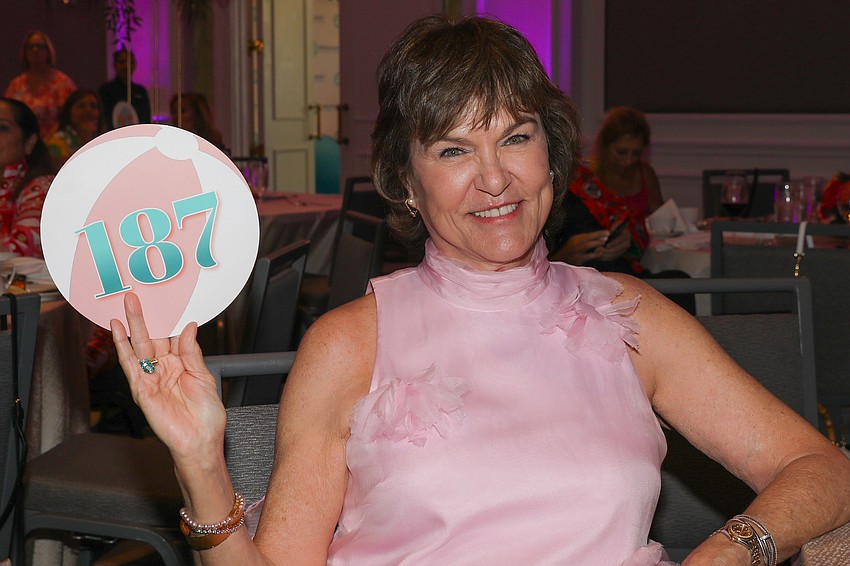 Teresa Jones and paddle #137 are waving high.