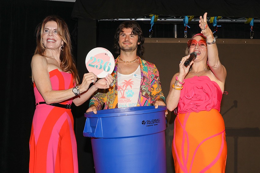 Renee Phinney, James La Londe and Jaime Marco pulled paddle #236 and are waiting for the winner to claim their prize.