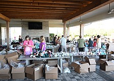 Esplanade residents have an assembly line to stuff Comfort Cases backpacks to be delivered to foster kids.