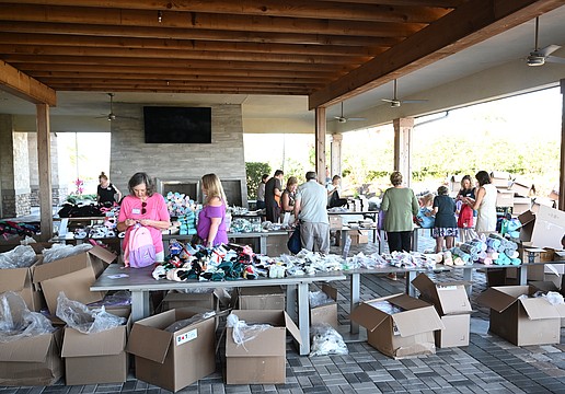 Esplanade residents have an assembly line to stuff Comfort Cases backpacks to be delivered to foster kids.