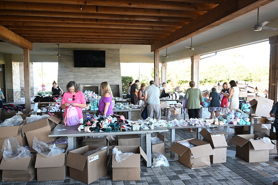 Esplanade residents have an assembly line to stuff Comfort Cases backpacks to be delivered to foster kids.