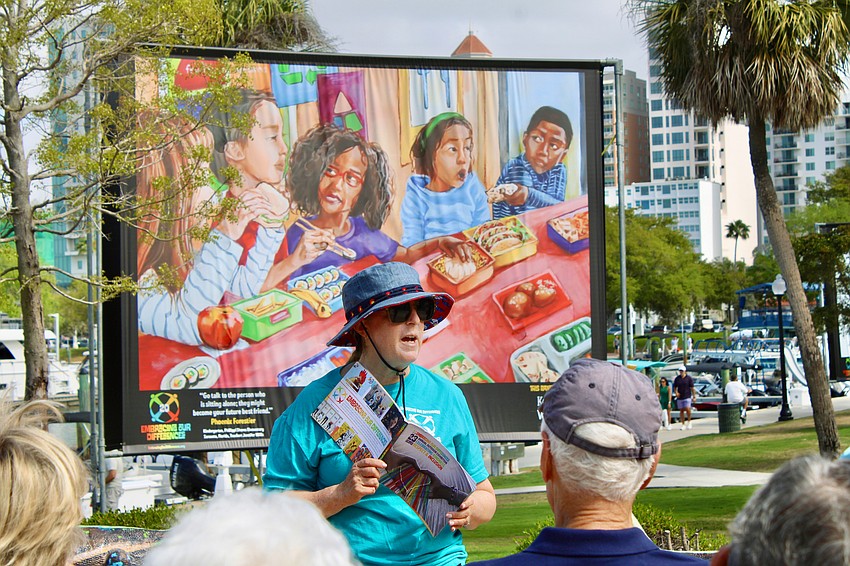 Temple Beth Israel's Rabbi Jessica Spitalnic Mates leads one of two groups of temple members on a March 13 tour of the Embracing Our Differences exhibit at Sarasota Bay Park. She describes a piece by student artist Lena Ko on inclusivity at lunch time, titled 