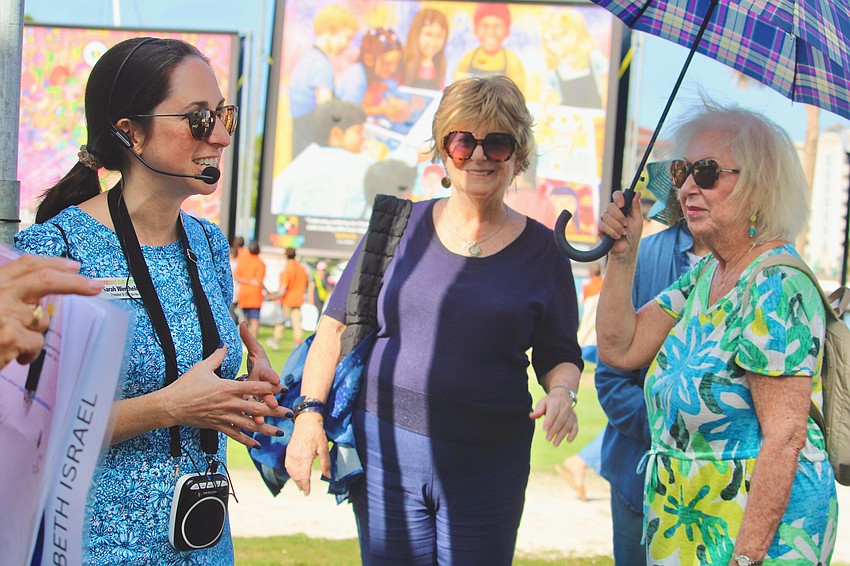 Embracing Our Differences, Inc. President and CEO Sarah Wertheimer joins Temple Beth Israel members to lead a tour of this year's exhibit at Sarasota Bayfront Park.