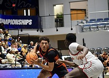 Junior guard/forward Isaiah Jenkins (left) looks for a pass during the FHSAA Class 7A boys basketball state championship between Sarasota and Miami Columbus. The Sailors fell, 53-50, on March 14 at Jacksonville's UNF Arena.