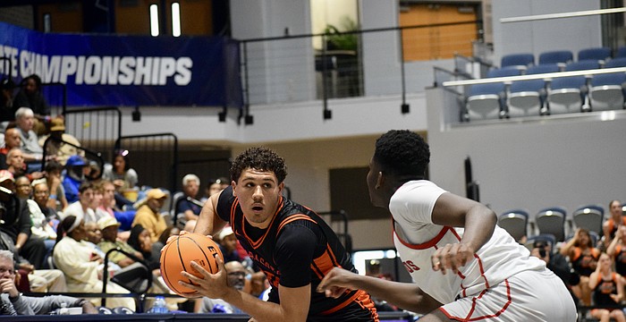 Junior guard/forward Isaiah Jenkins (left) looks for a pass during the FHSAA Class 7A boys basketball state championship between Sarasota and Miami Columbus. The Sailors fell, 53-50, on March 14 at Jacksonville's UNF Arena.