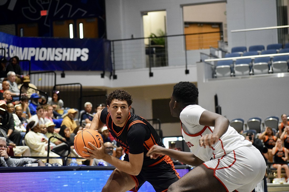 Junior guard/forward Isaiah Jenkins (left) looks for a pass during the FHSAA Class 7A boys basketball state championship between Sarasota and Miami Columbus. The Sailors fell, 53-50, on March 14 at Jacksonville's UNF Arena.