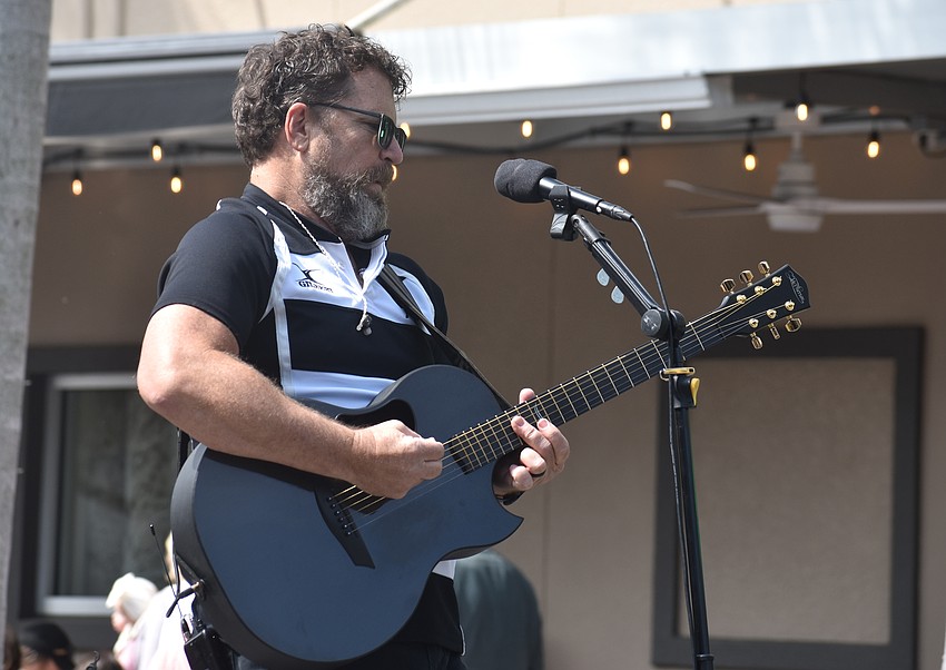 Brian Crowe, the lead singer of the Sarasota-based White Crowe Band performs on Lakewood Main Street for St. Patrick's Day.