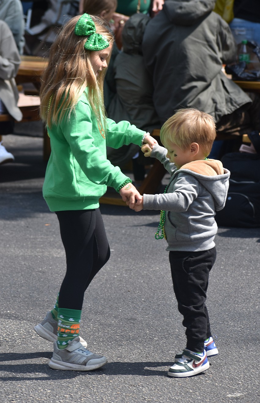 Palmetto's Nora Deland, 6, leads her younger brother Liam Deland, 2, in dance to celebrate St. Patrick's Day.