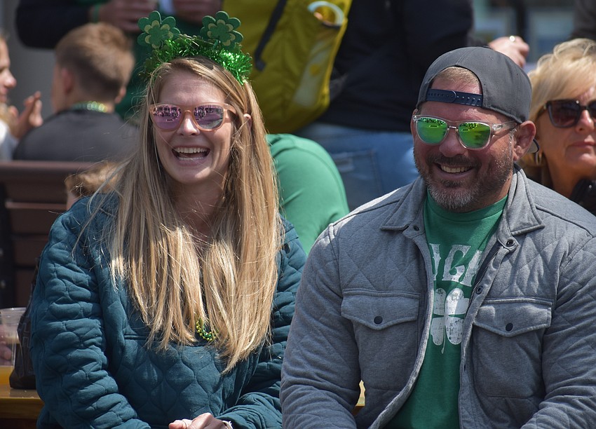 Palmetto's Sam Deland and Russ Deland watch as their children Nora and
Liam dance with one another on St. Patrick's Day.